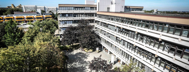 A long building surrounded by trees